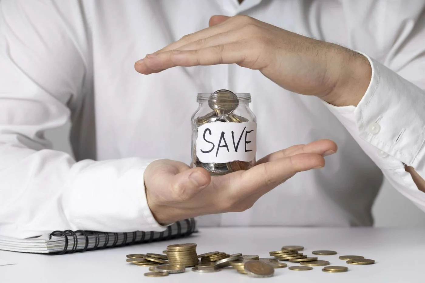 Glass jars filled with coins and bills, representing cost savings from hiring the right bathroom remodeling contractor