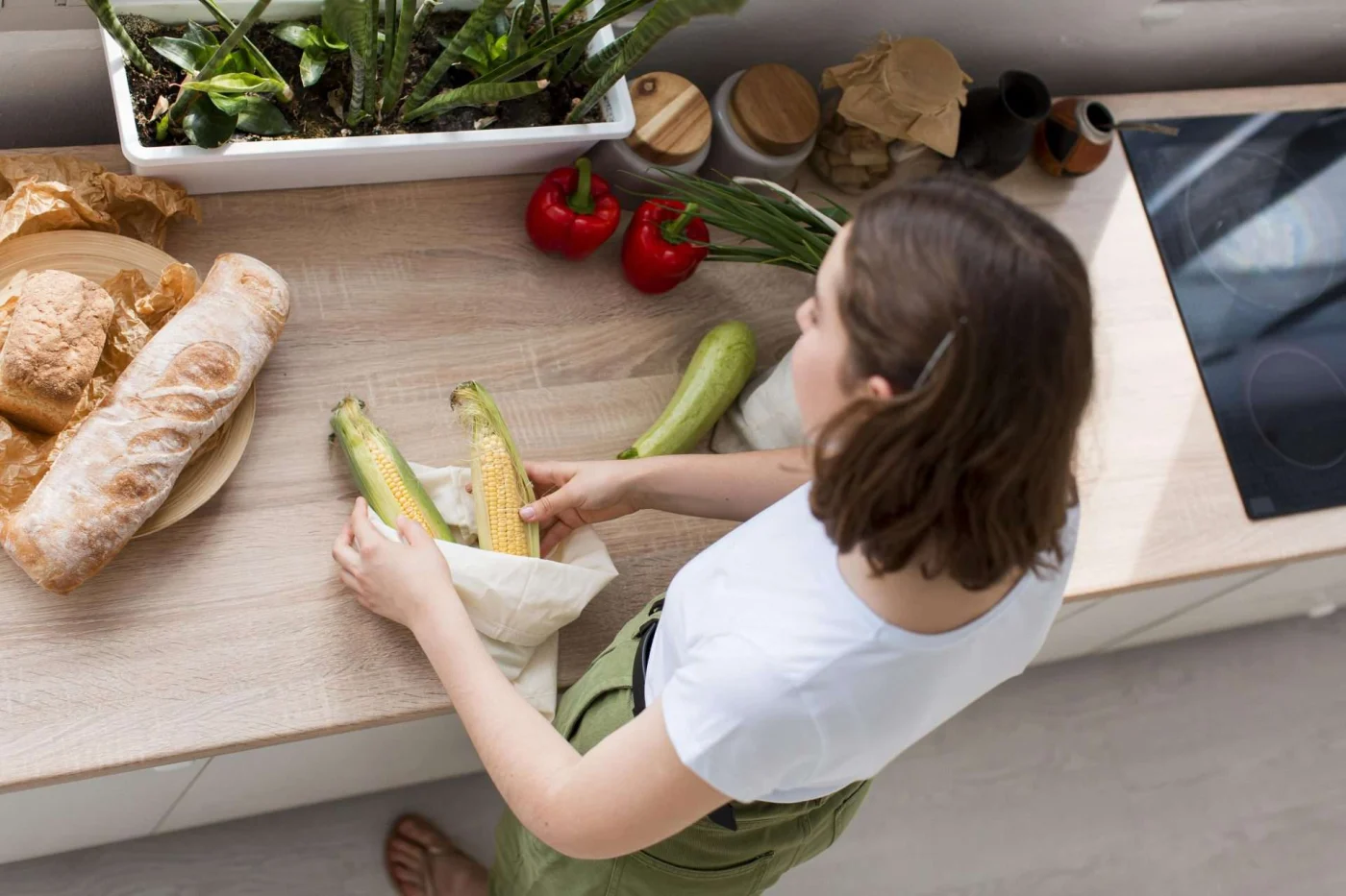 Woman organizing organic groceries, highlighting sustainable habits for an eco-friendly kitchen remodel