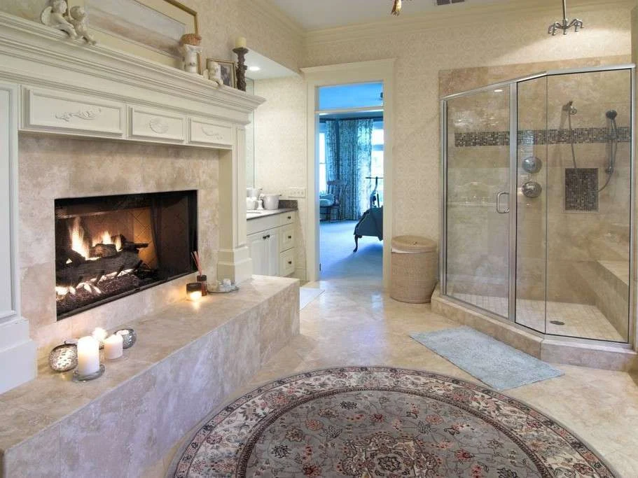 Beautiful remodeled bathroom with step-in shower and fireplace, all covered in gorgeous large panel tiling