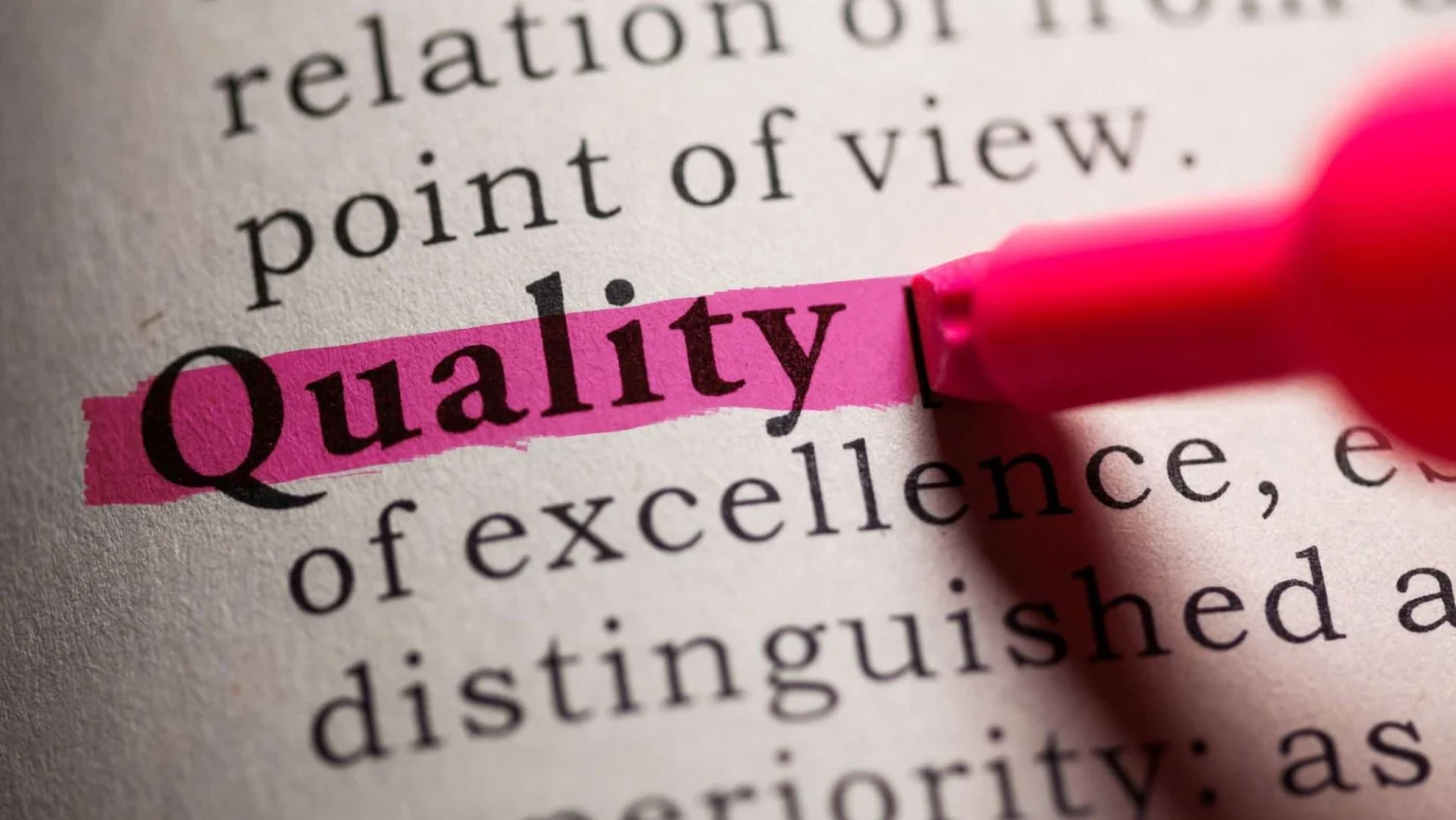 A dictionary definition of the word quality that is highlighted in pink