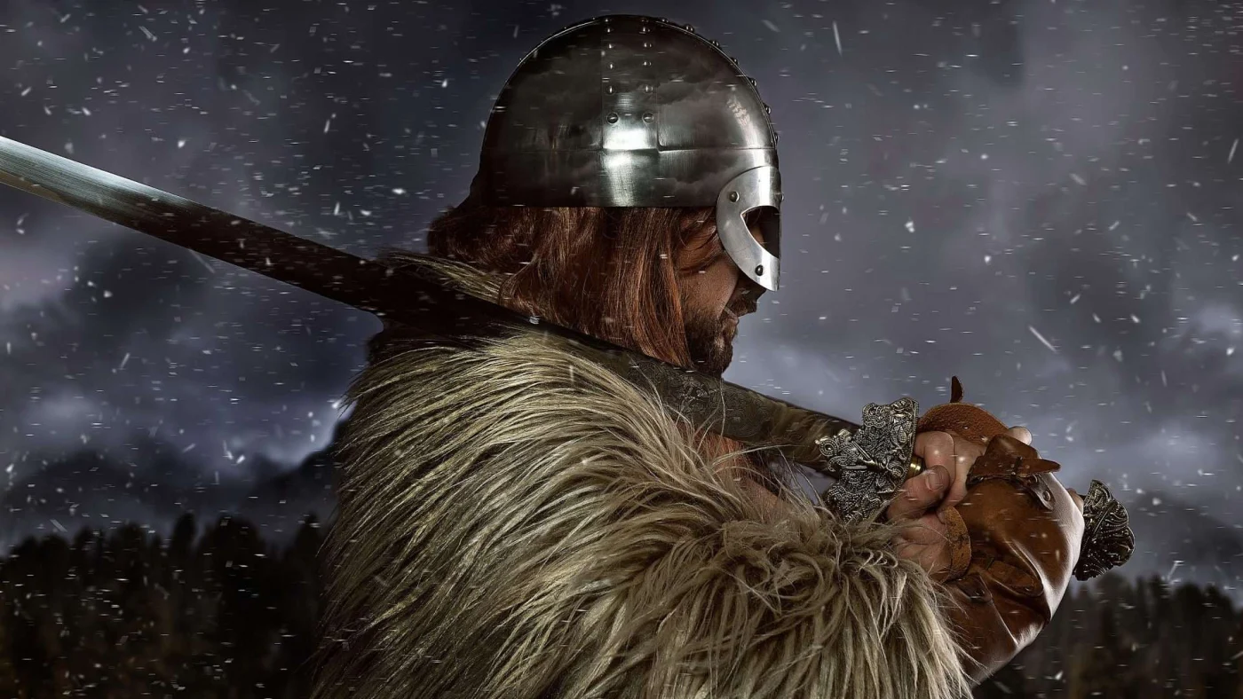 Viking warrior carrying sword walks head-on into snow