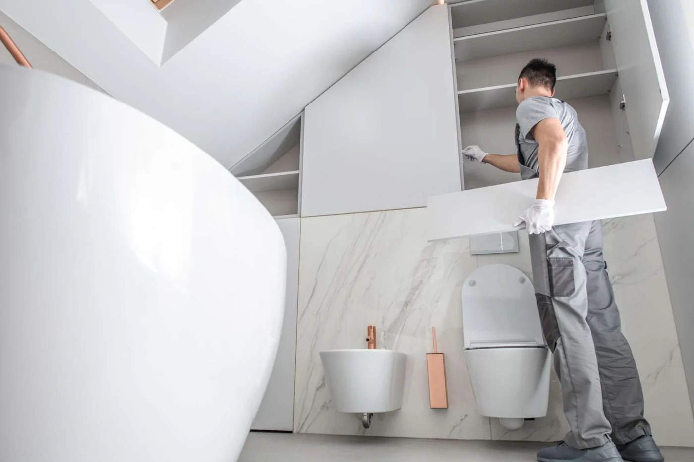 Man remodeling bathroom, illustrating comparison between DIY and professional renovation work