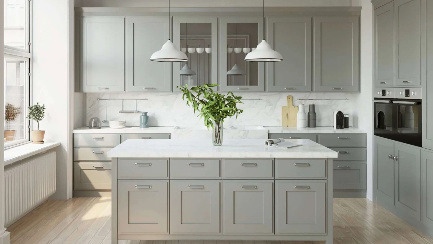 A kitchen with gray cabinets and white countertops