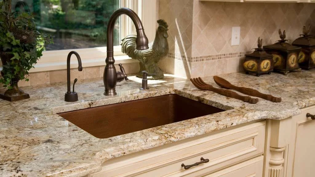 Stunning kitchen remodel with granite counters and aged bronze faucet and sink by Jericho Home Improvements in Kansas City