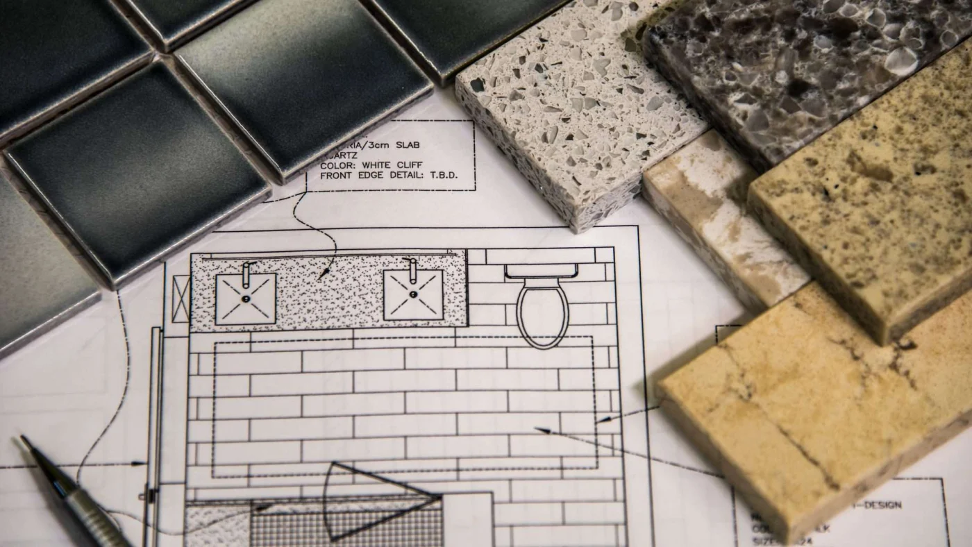 Bathroom remodeling plan with a pen and tile samples