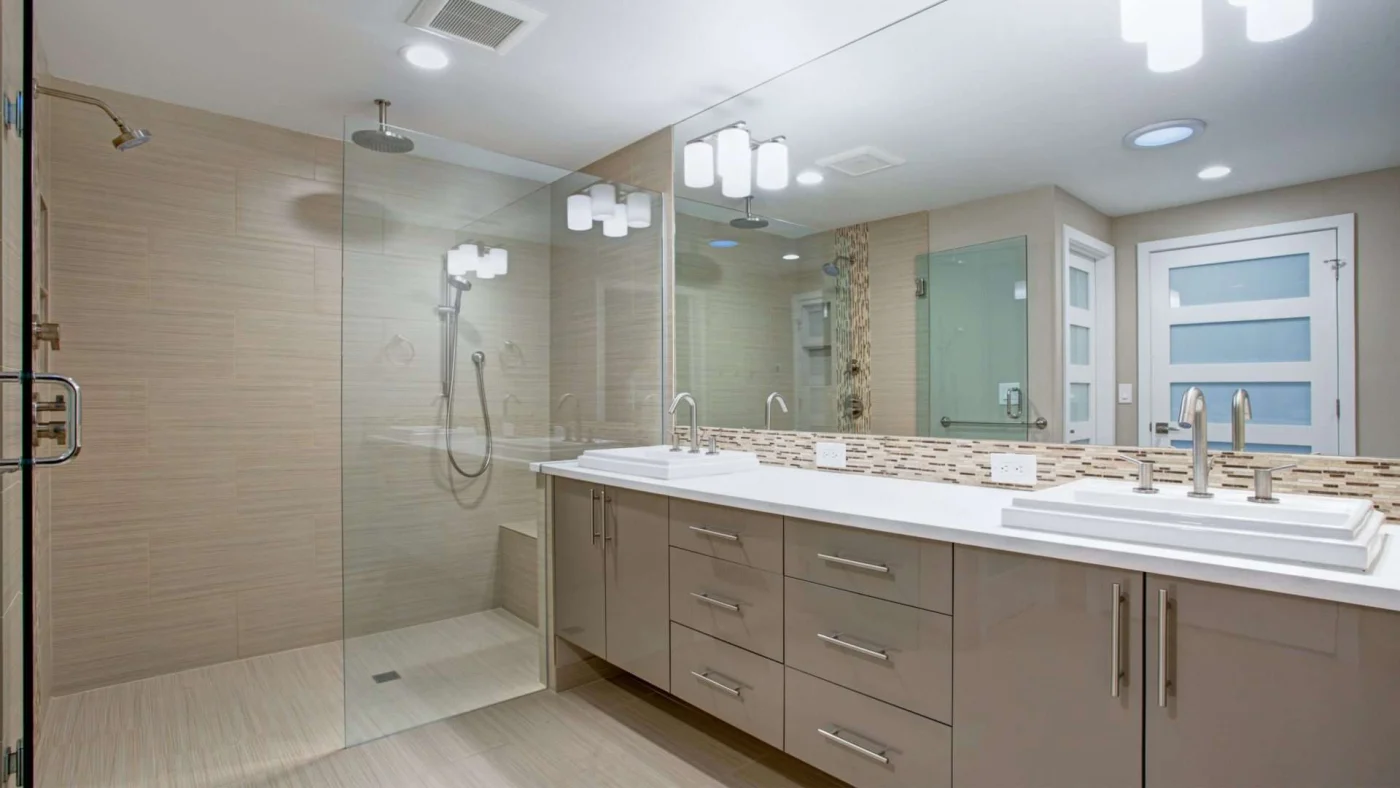 A large bathroom with a double vanity and a glass-enclosed walk-in shower