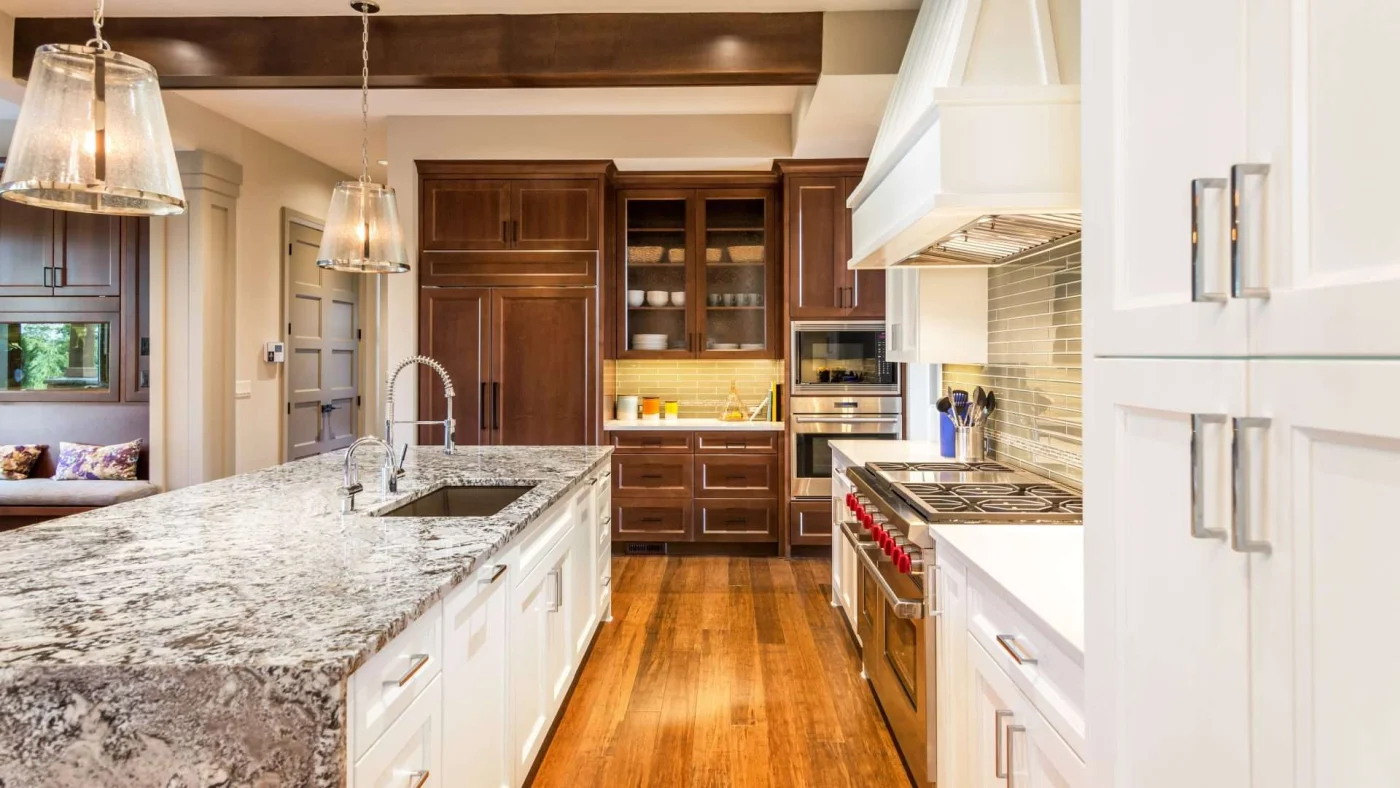 Home in Shawnee, KS with newly renovated kitchen with new hardwood flooring, marble countertops, and dark wooden cabinets
