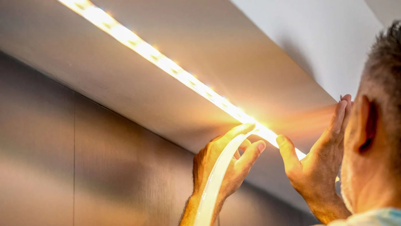 Kitchen remodeler installing new under-cabinet LED lighting