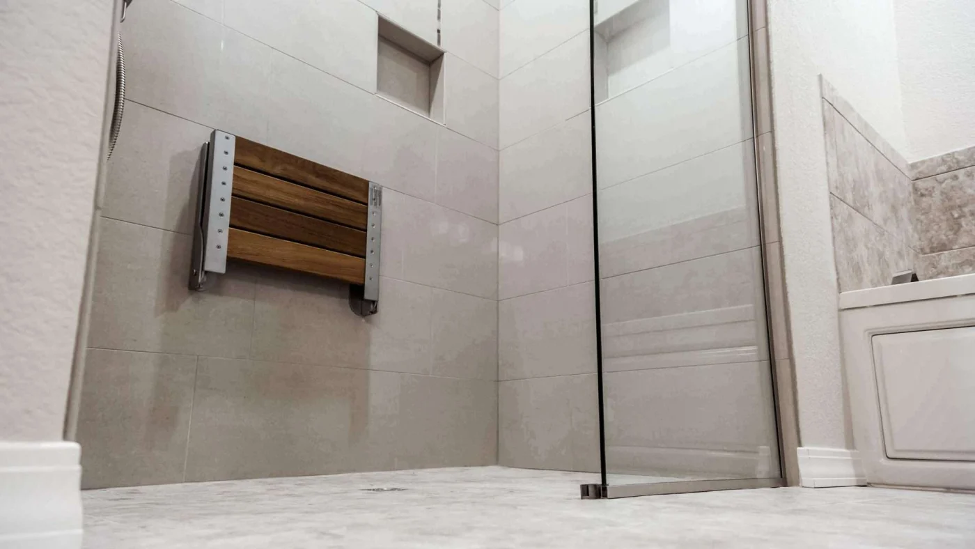Accessible Remodeled Bathroom Lenexa Ks Jericho Home Improvements Closeup of a walk-in shower with a built-in seat and a glass enclosure