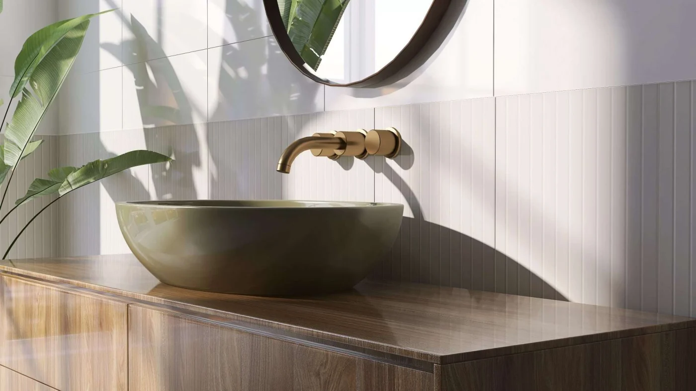 A bathroom vanity with a vessel sink and high-quality faucet with the morning sunlight shining on it