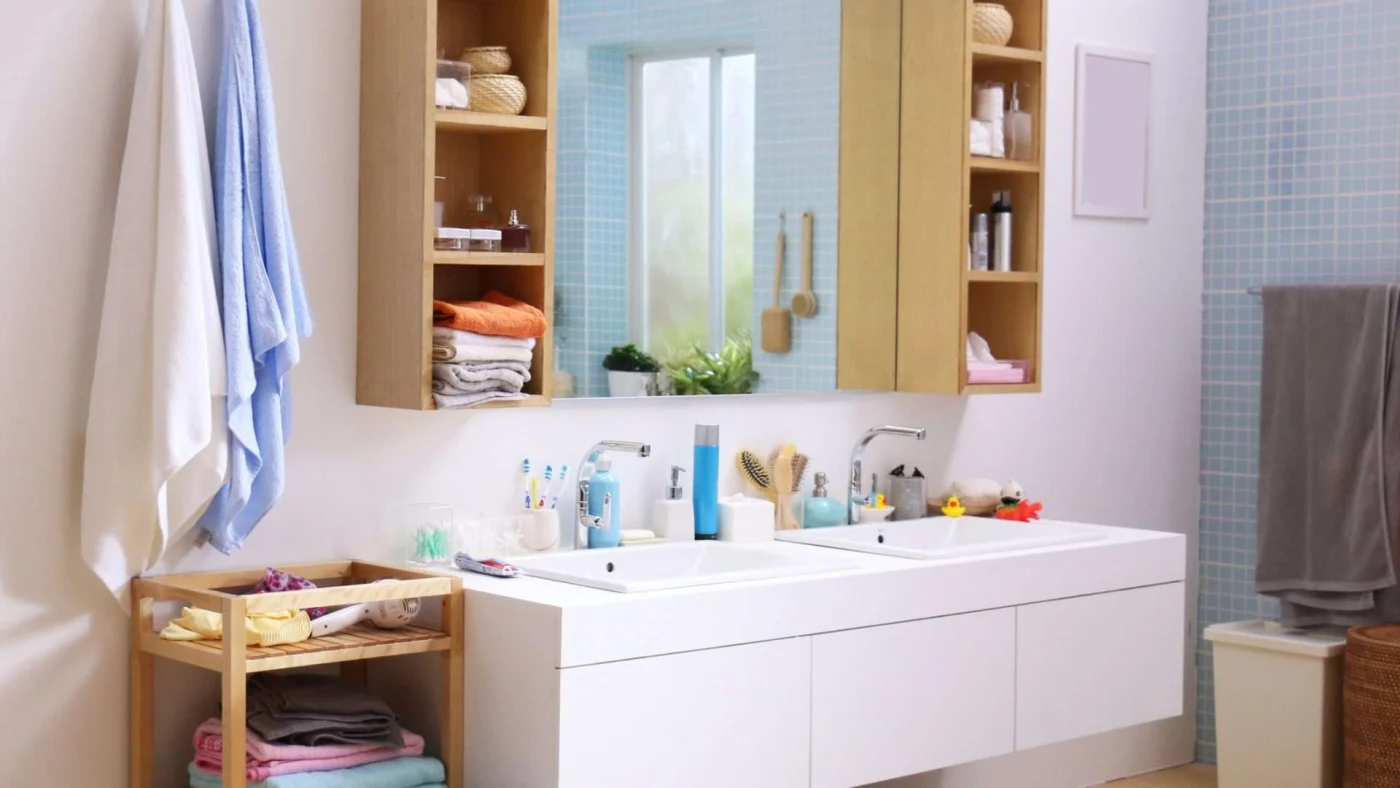 A Place In Every Morning View of a large, low double-sink bathroom vanity designed for kids’ use