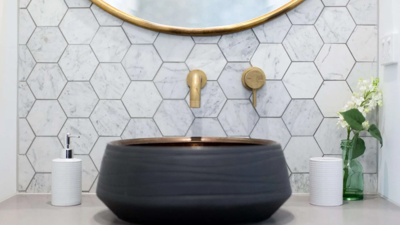 Close frontal view of a beautiful bowl sink with custom fixtures in a remodeled bathroom