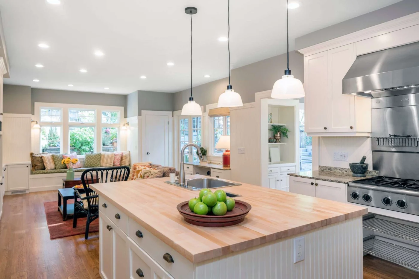 Luxury Kitchen Interior In White With Wooden Floor And Kitchen I Overland Park kitchen remodel with hanging and high-hat lights worked on by Jericho Home Improvement