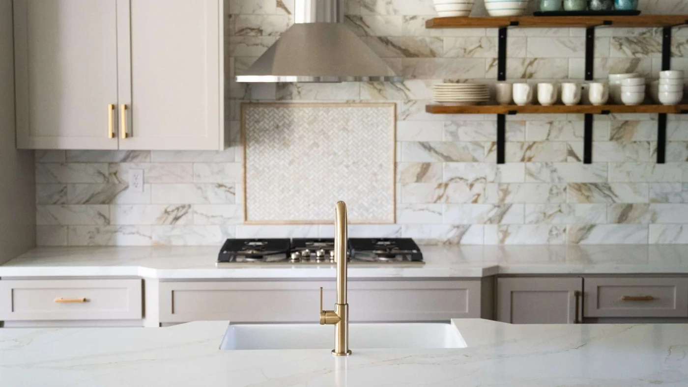 Gorgeous marble countertops, tile backsplash and cabinetry in a Lenexa, KS, kitchen