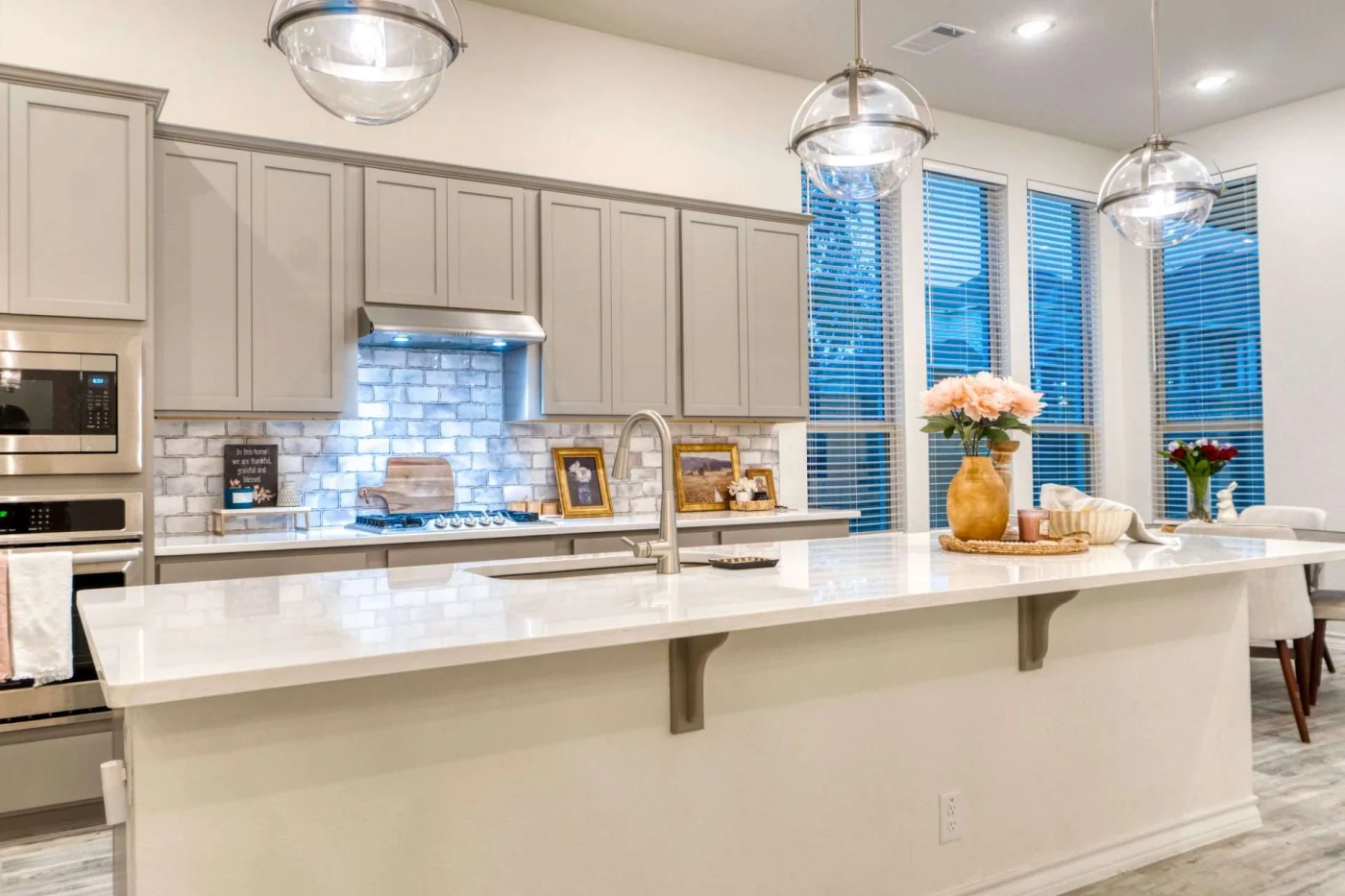 A lovely kitchen remodeling in Lenexa, KS, with marble countertops, tile backsplash, and modern cabinets