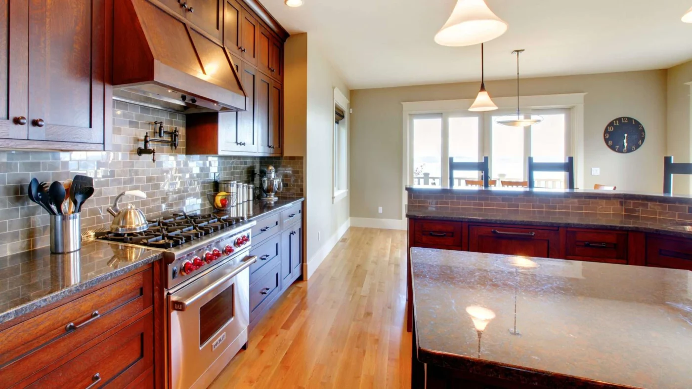 Kitchen with beautiful U-shaped bar with wooden cabinets and hardwood flooring in Shawnee, KS
