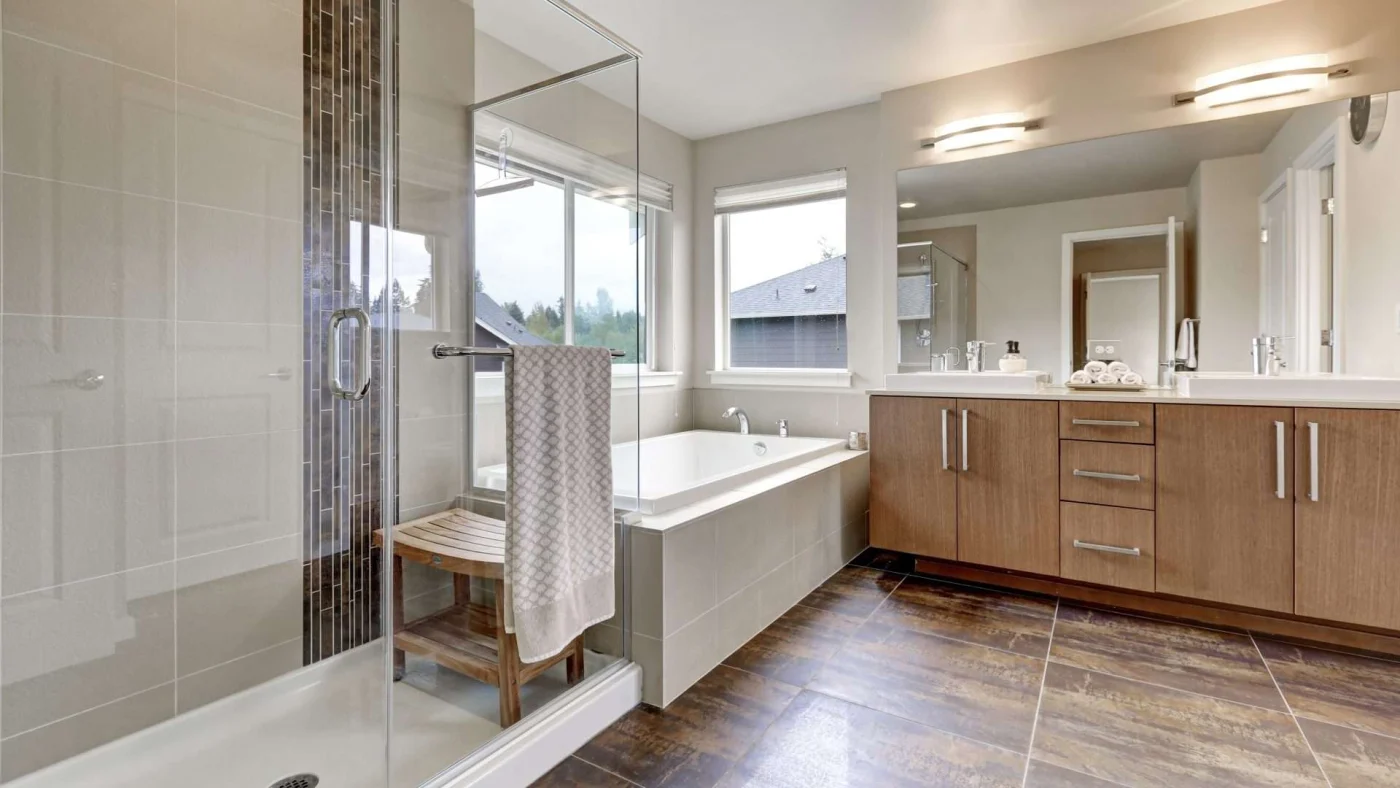 A large bathroom with a walk-in shower, bathtub, and large vanity
