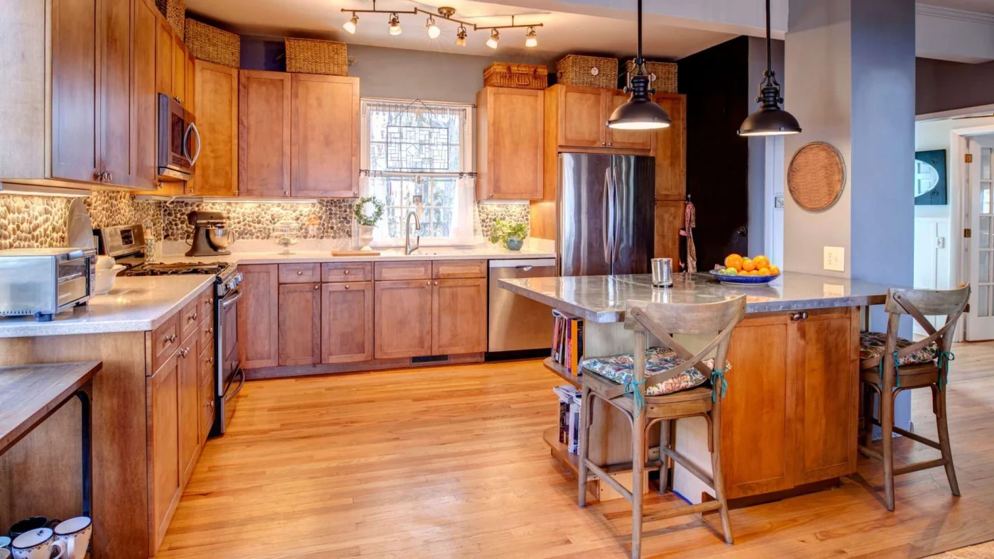 Shawnee, KS kitchen with new wood cabinets, hardwood flooring, and beautiful stone countertops by Jericho Home Improvements.