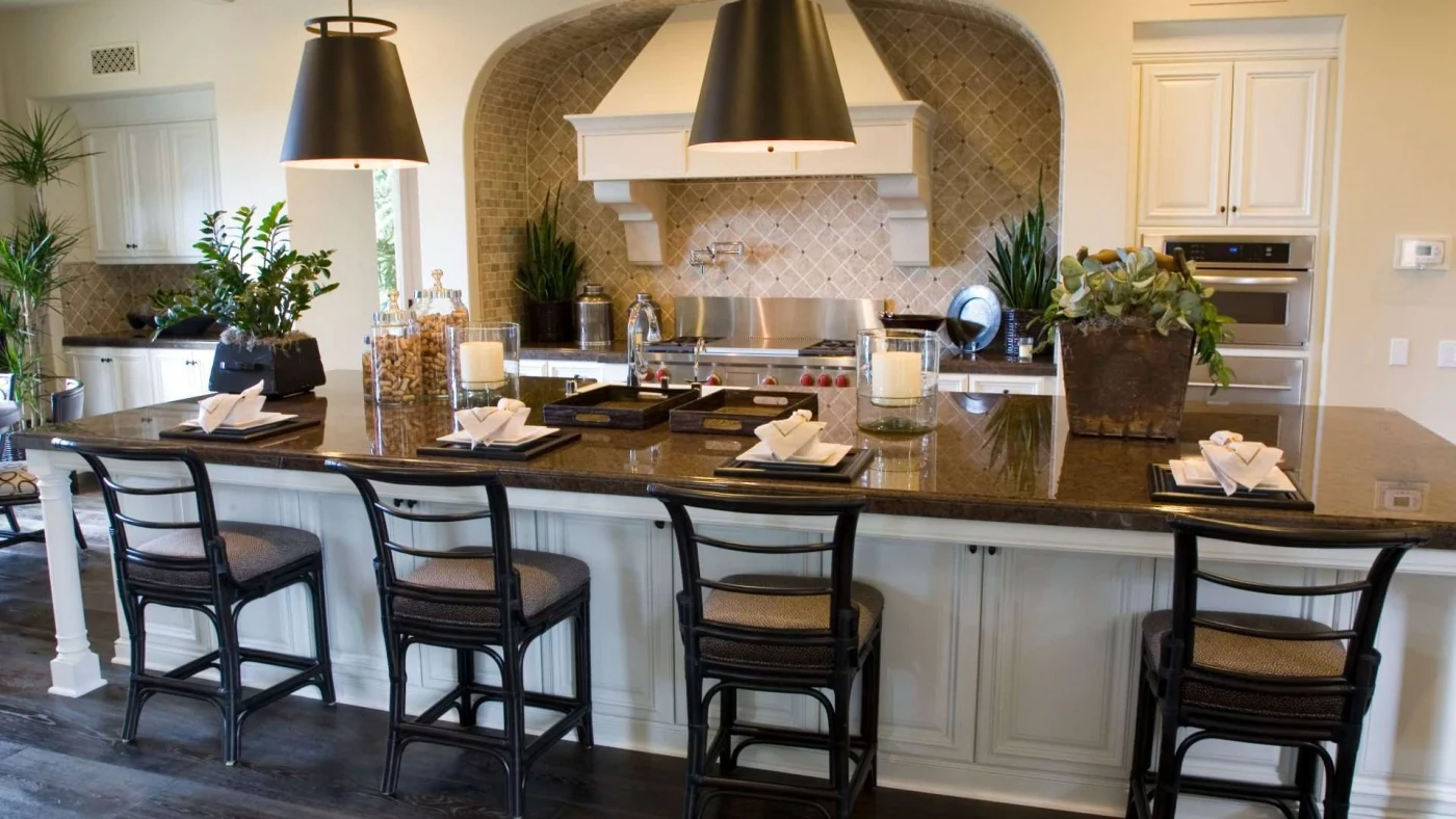 Close interior view of a beautifully redone kitchen with a large, dark-topped central island