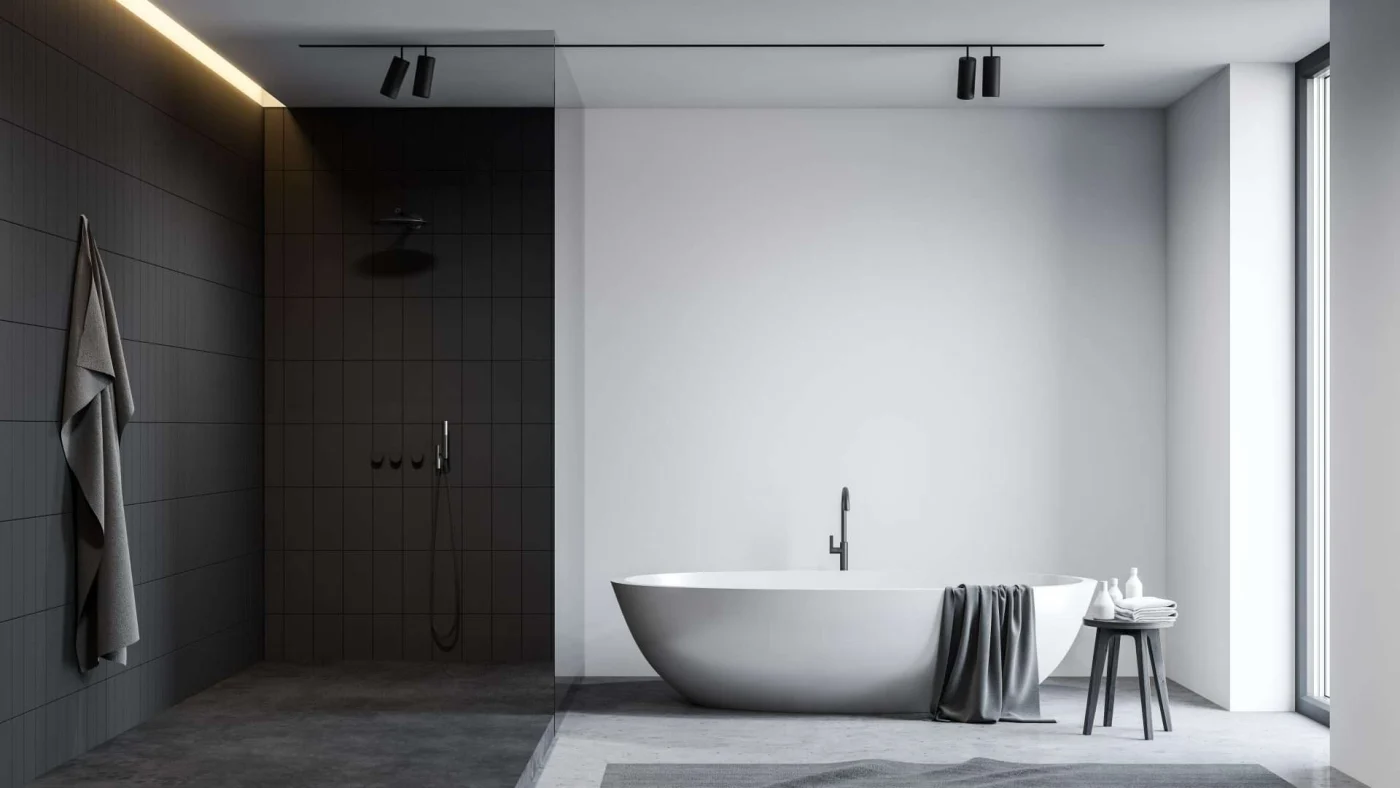 A black and white themed bathroom with a soaker tub