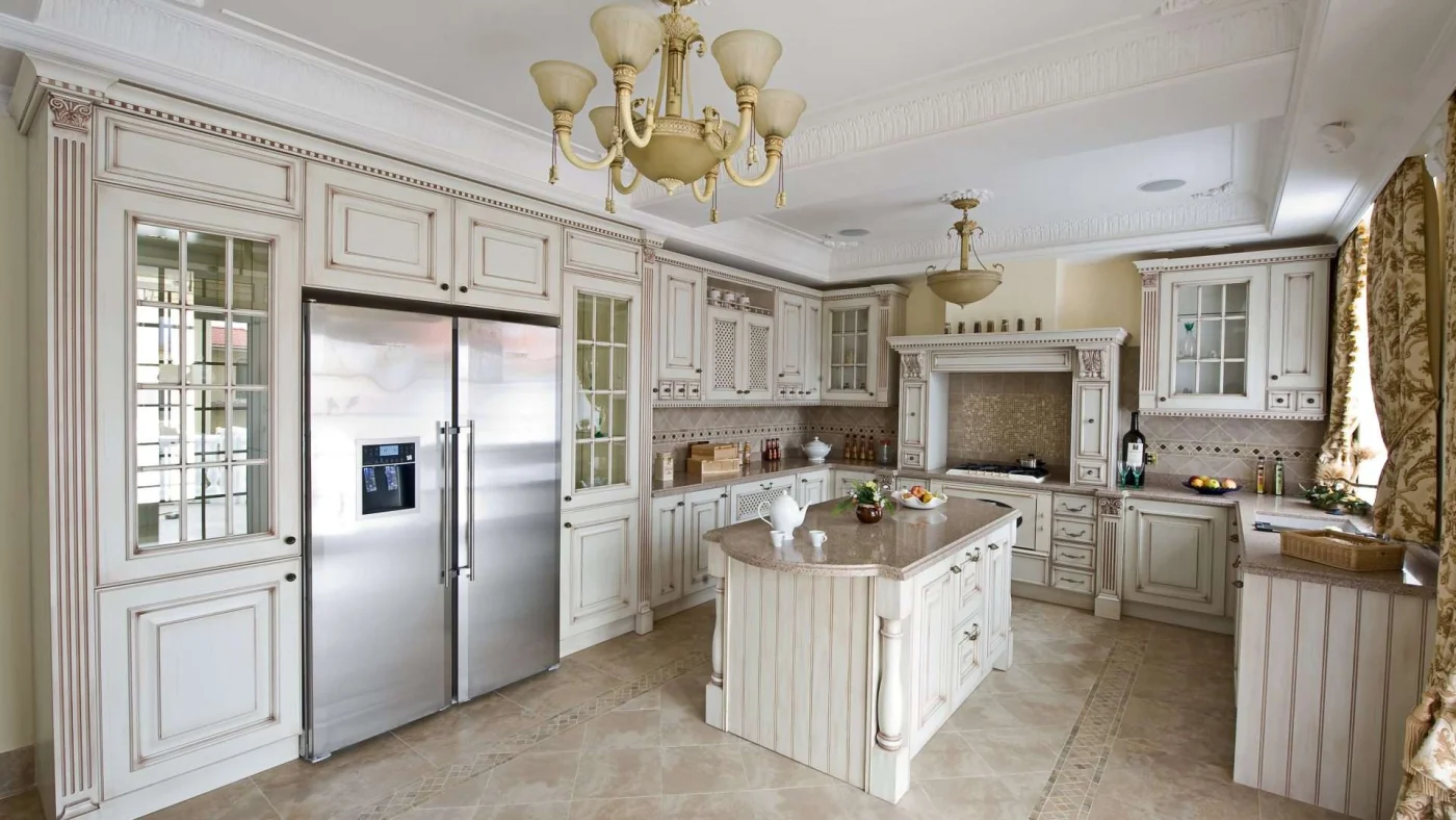A kitchen with white cabinets, brown countertops, and stainless steel appliances