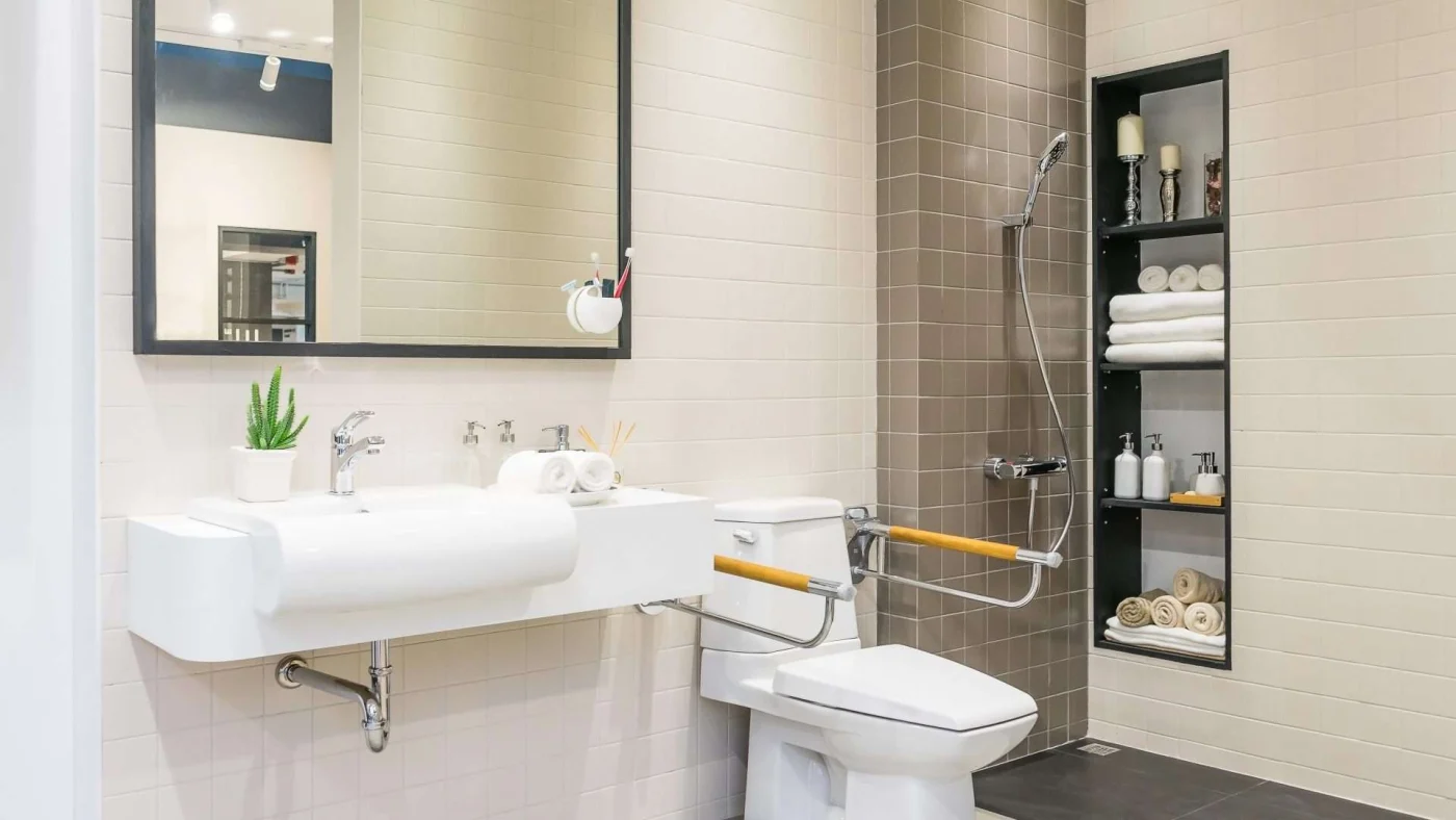 Close view of an easy-access sink, toilet, and shower in a modern remodeled bathroom