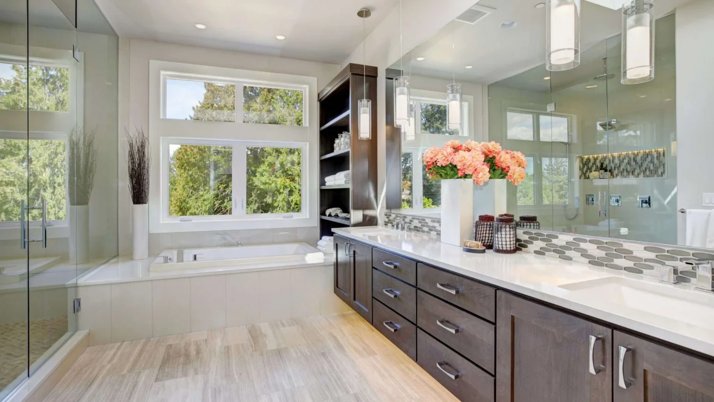 An expansive bathroom with an extra-long vanity, walk-in shower, and separate bathtub