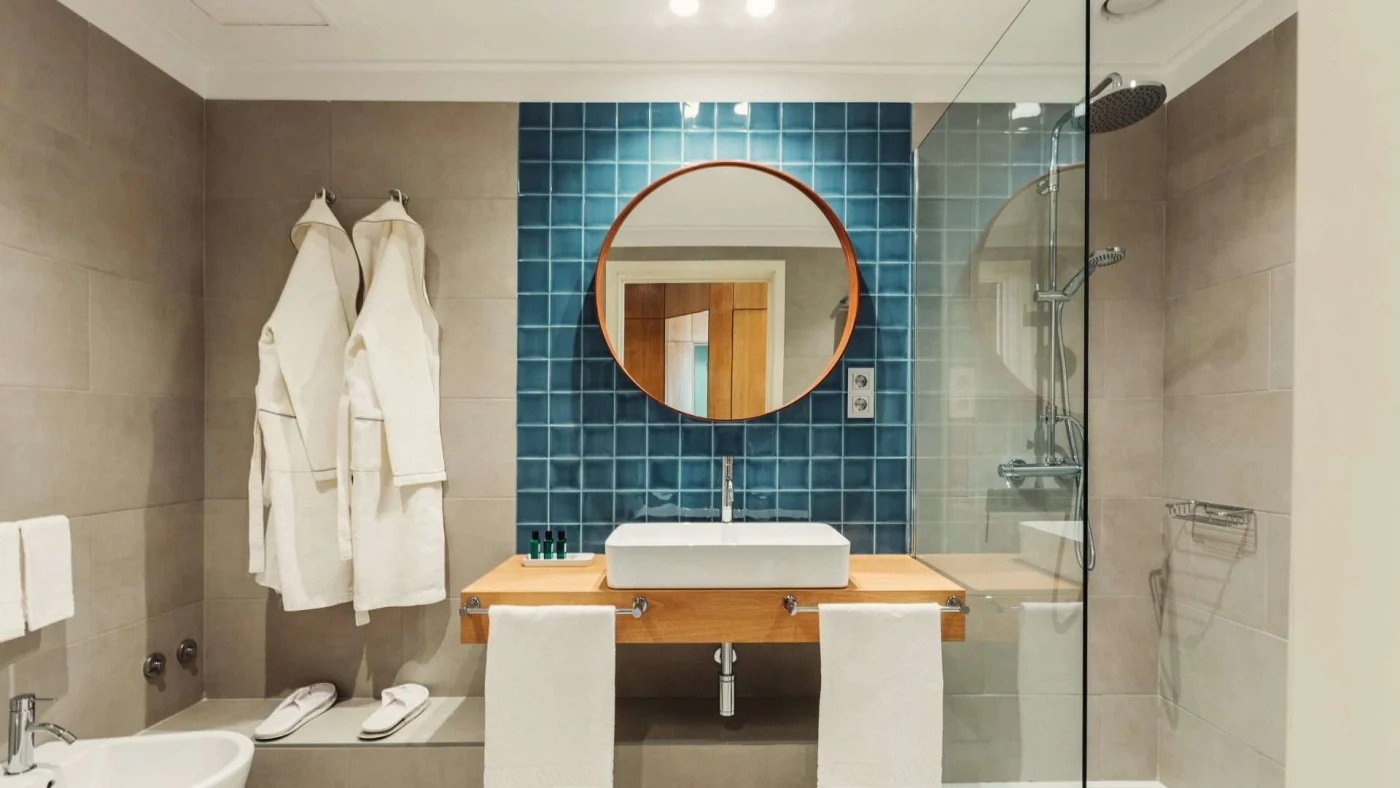 Frontal view of a beautifully done bathroom with a shower, bathtub and tile accent wall