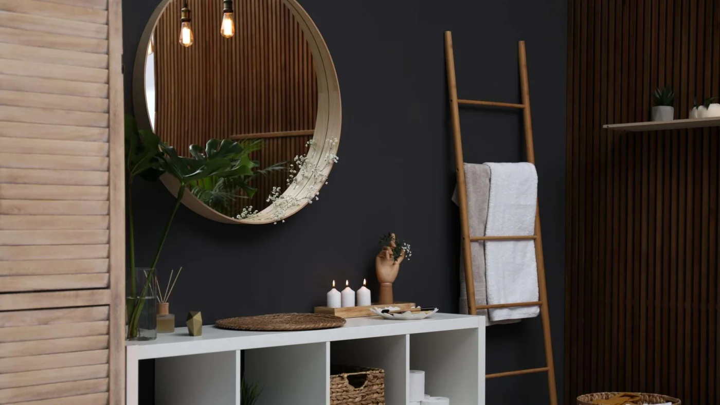 Closeup of a vanity area in a stylish bathroom with black-painted walls