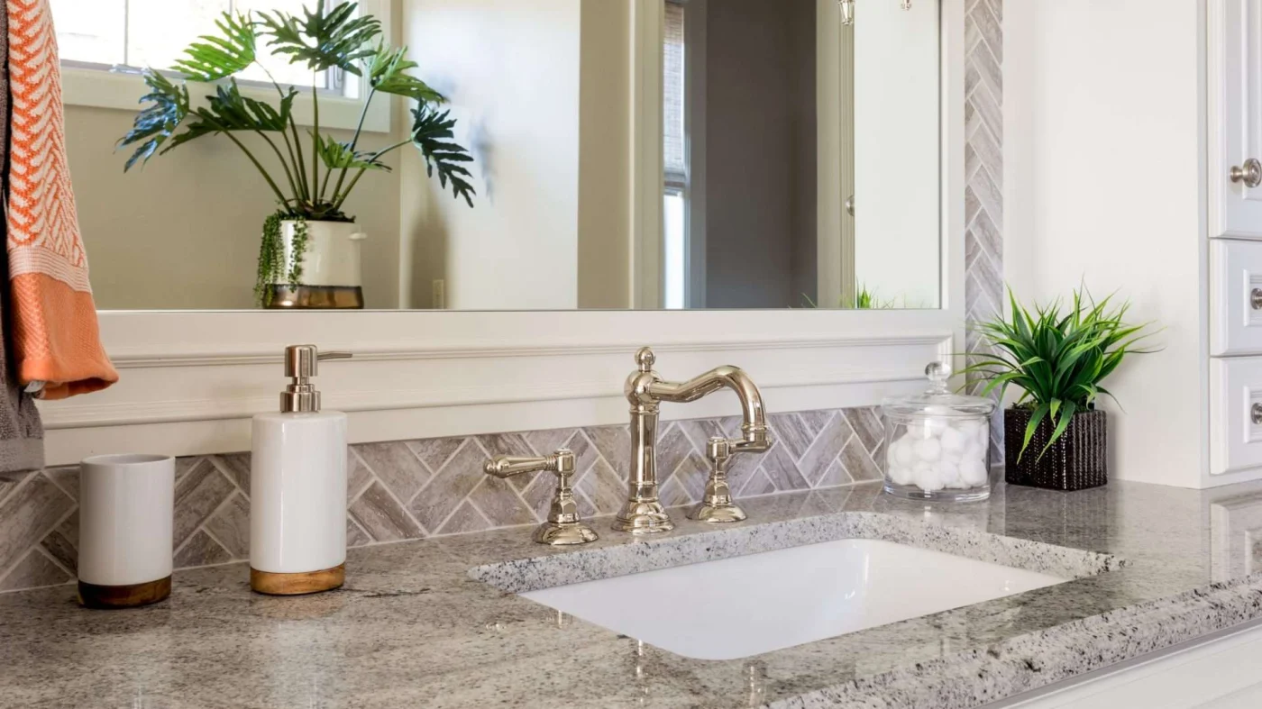 A closeup of a vanity with a gold faucet