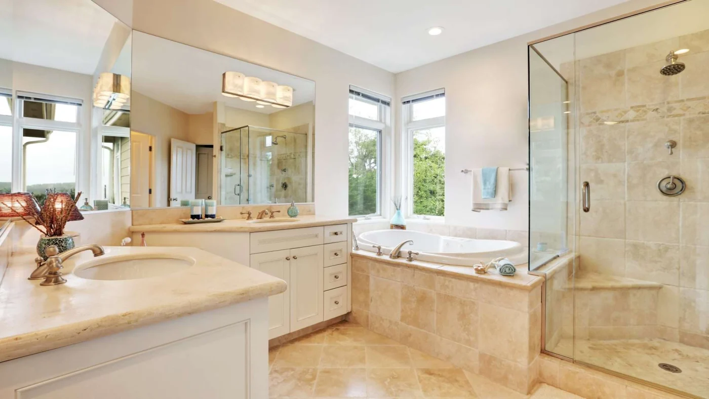 A cream-colored bathroom with a walk-in shower and separate bathtub