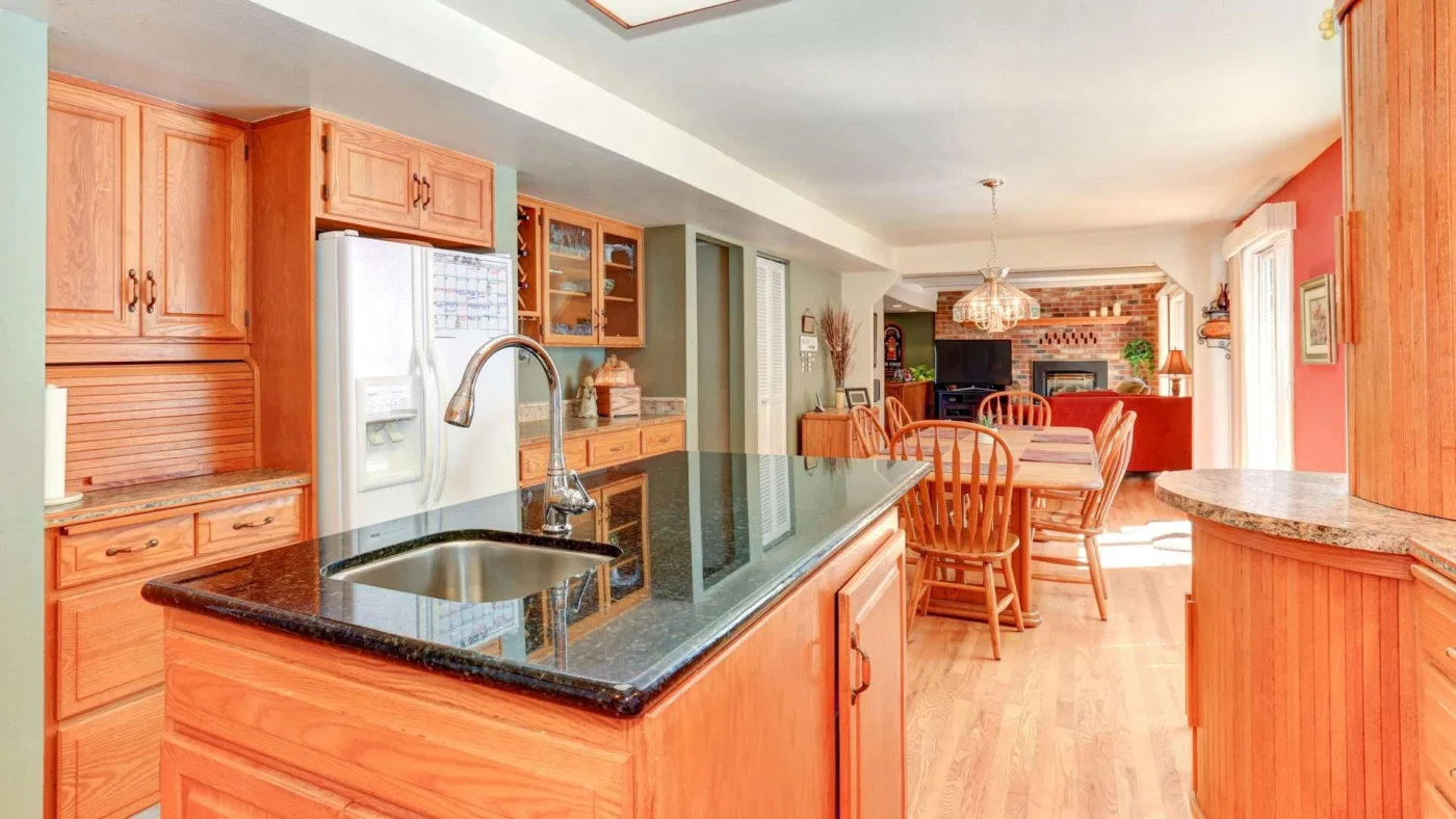 Bright oak kitchen with custom cabinets and natural stone countertops