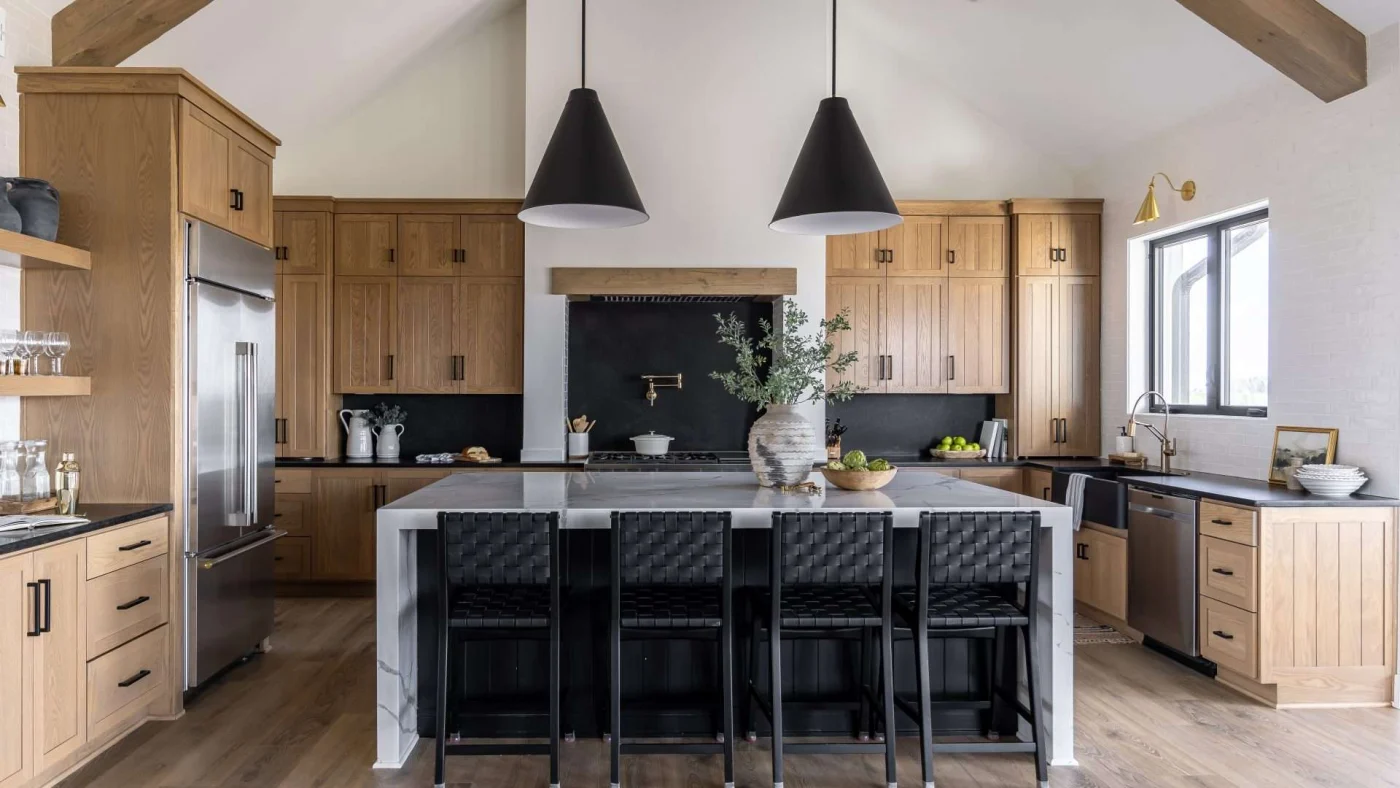 Frontal view of a huge remodeled kitchen with a vaulted ceiling, tons of cabinets, and a large central island
