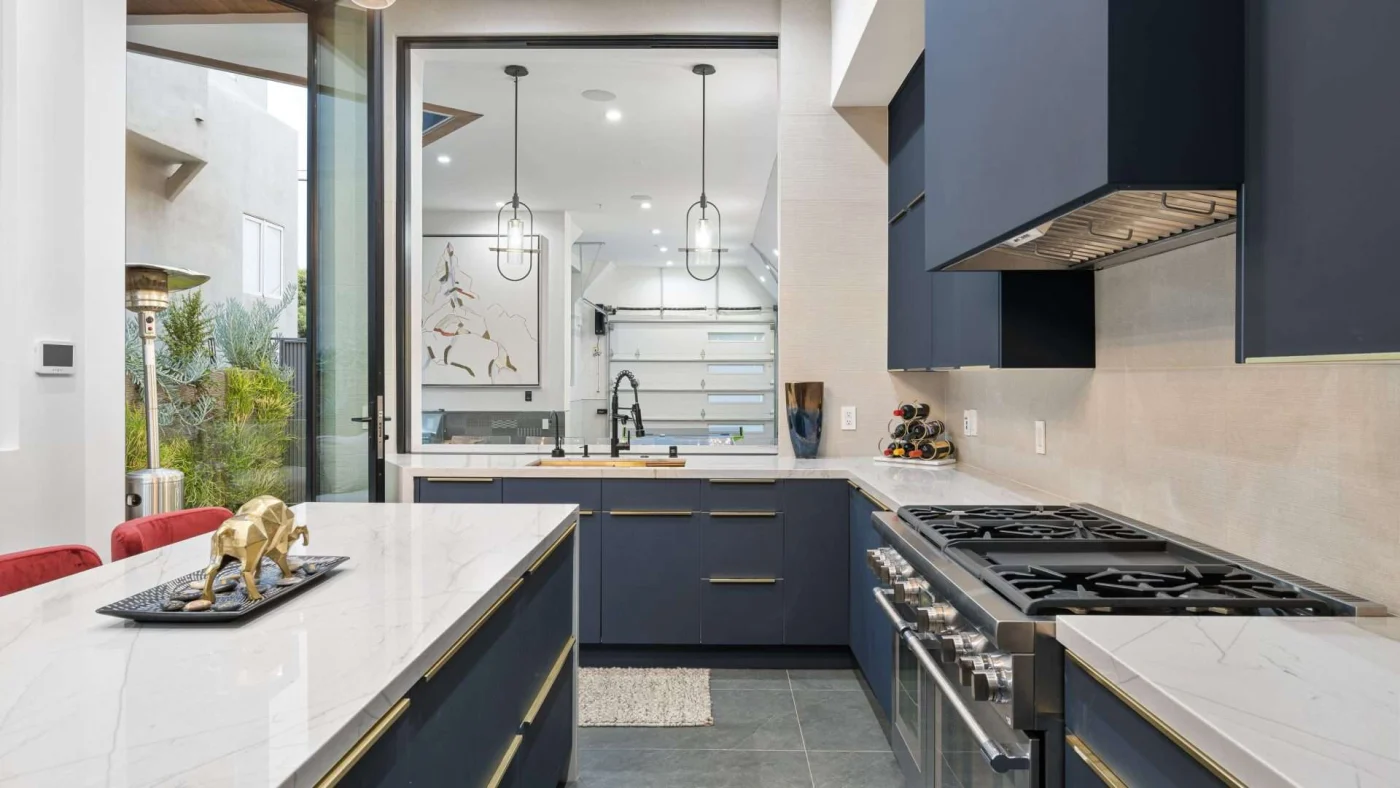 View of a beautiful galley kitchen with an island with seating on one side