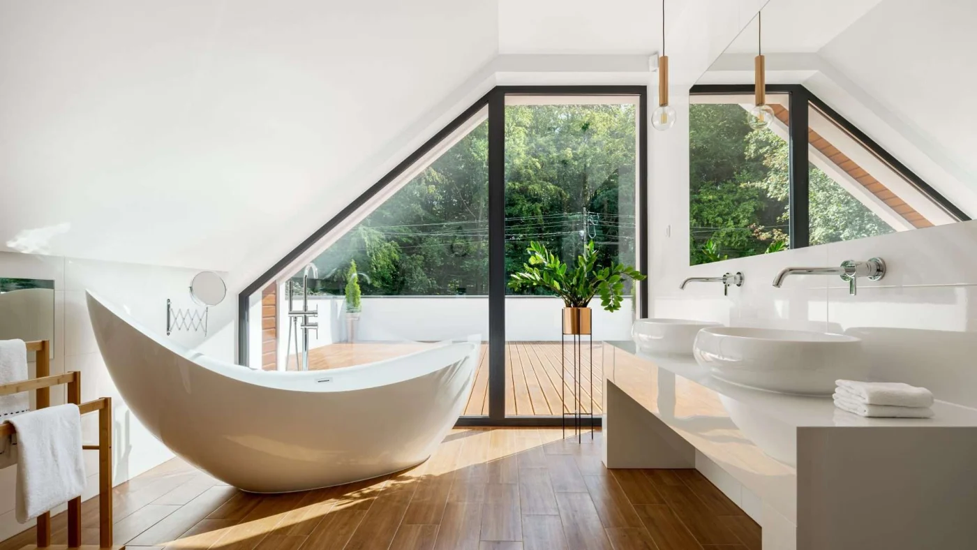 Close view of a spectacularly remodeled upstairs bathroom with a crescent-shaped freestanding bathtub.