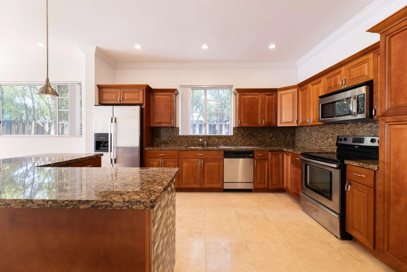 Brown mingled granite countertops throughout refinished kitchen