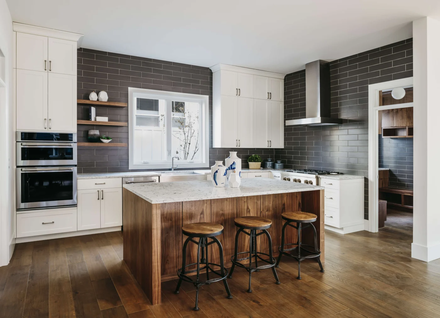 A kitchen with white cabinets and a wood island in it to upgrade to a modern style.