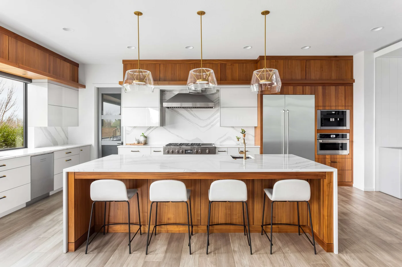 A kitchen with wooden cabinets and splashes of white for a comfortable look.